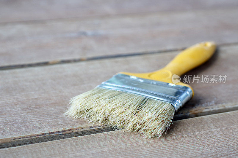 Paint brush on the wooden floor